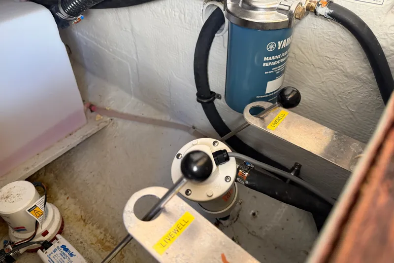 Slide: The Image of 2024 Grady-White Fisherman 236 boat engine compartment with marine fuel filter and livewell system. - 87