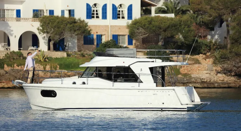 Slide: The Image of Manufacturer Provided Image: 2020 Beneteau Swift Trawler 30 cruising near a lighthouse on calm waters. - 11