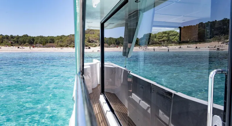 Slide: The Image of Manufacturer Provided Image: 2020 Beneteau Swift Trawler 30 cruising near a coastal villa. - 17