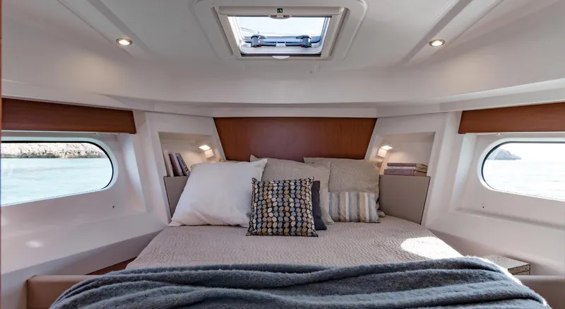 Slide: The Image of Manufacturer Provided Image: Cozy bedroom interior of 2020 Beneteau Swift Trawler 30 with natural light and elegant decor. - 28