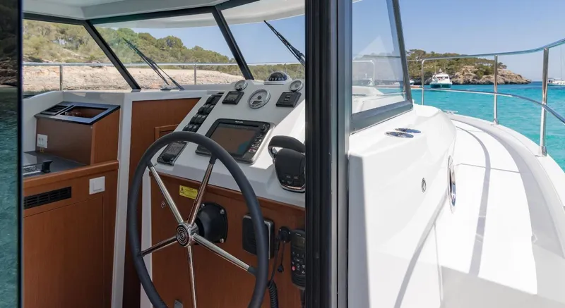 Slide: The Image of Manufacturer Provided Image: 2020 Beneteau Swift Trawler 30 helm with scenic ocean view. - 30
