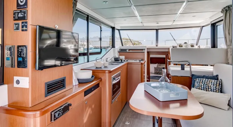 Slide: The Image of Manufacturer Provided Image: Interior of 2020 Beneteau Swift Trawler 30, featuring modern kitchen and cozy seating area. - 32