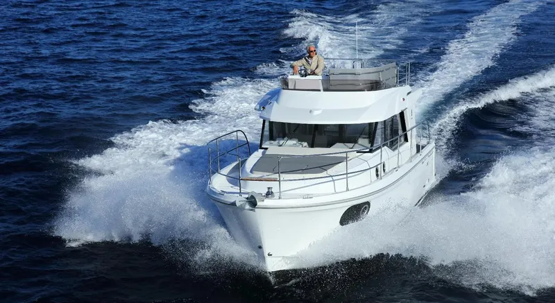 Slide: The Image of Interior of 2020 Beneteau Swift Trawler 30 with cozy seating and wooden table. - 6