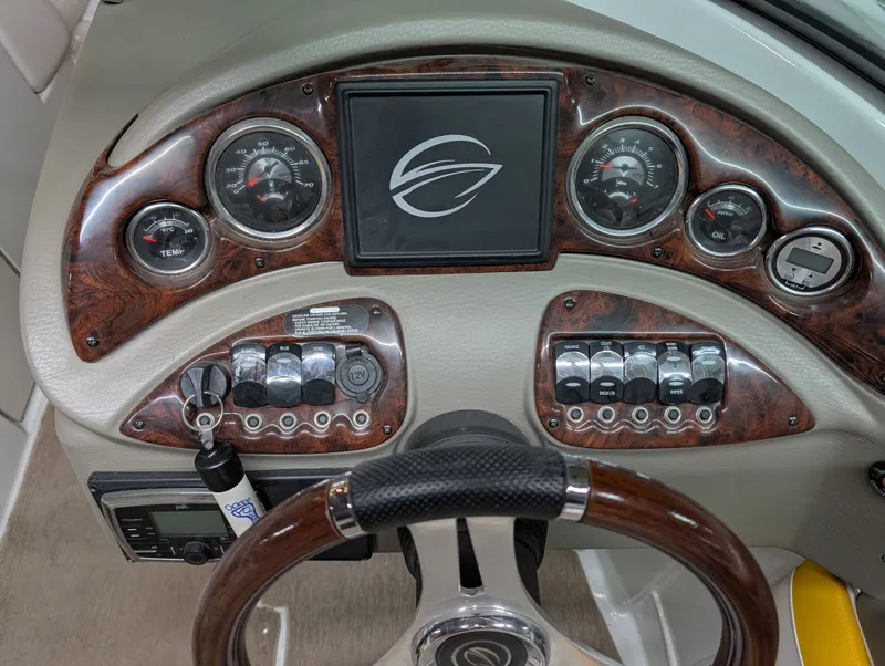 Slide: The Image of Dashboard of a 2015 Crownline Eclipse E6 boat with wood trim. - 15
