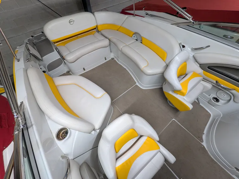 Slide: The Image of Interior of a 2015 Crownline Eclipse E6 boat with yellow and white seating. - 16