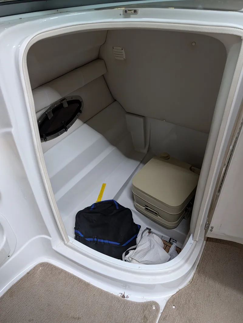 Slide: The Image of Interior of a 2015 Crownline Eclipse E6 boat with portable toilet. - 17