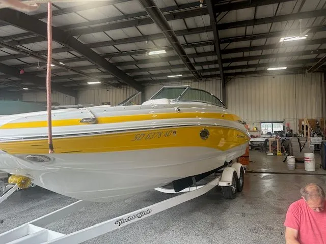 Slide: The Image of 2015 Crownline Eclipse E6 boat in yellow on trailer inside warehouse. - 3