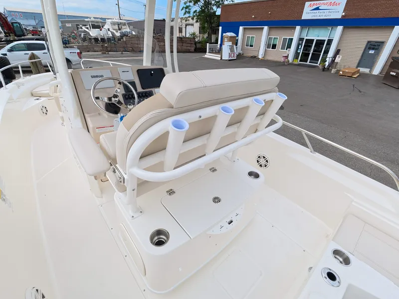 Slide: The Image of The image shows the cockpit of a Boston Whaler 220 Dauntless with beige seats and rod holders. - 9