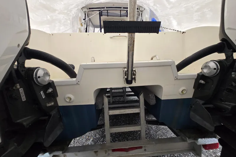 Slide: The Image of 2005 World Cat 250 DC boat stern view with dual engines and ladder. - 12