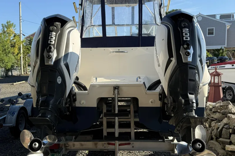 Slide: The Image of 2005 World Cat 250 DC boat with dual 200 HP outboard engines on a trailer. - 15
