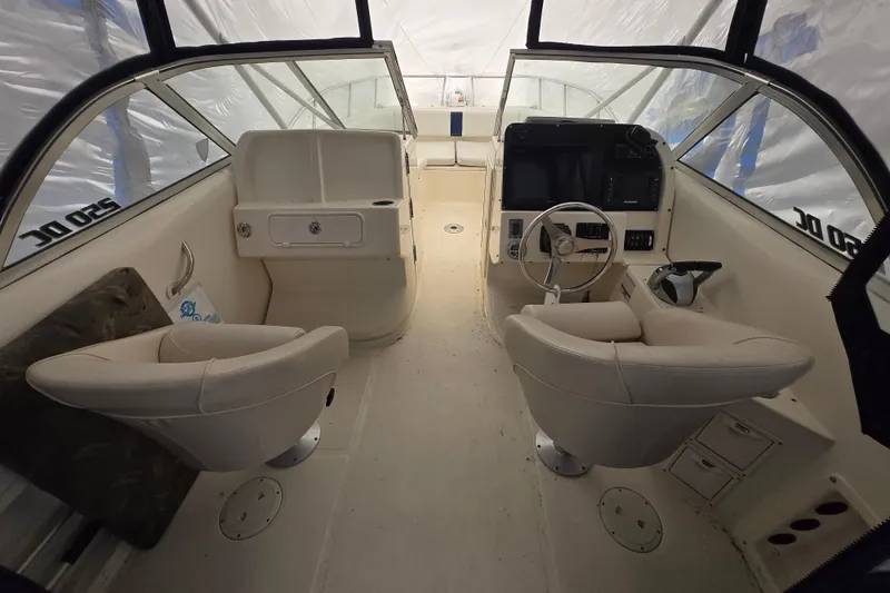Slide: The Image of Interior of a 2005 World Cat 250 DC boat with dual seating and steering console. - 2