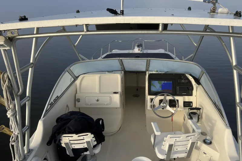 Slide: The Image of 2005 World Cat 250 DC boat interior with steering wheel and navigation system. - 4