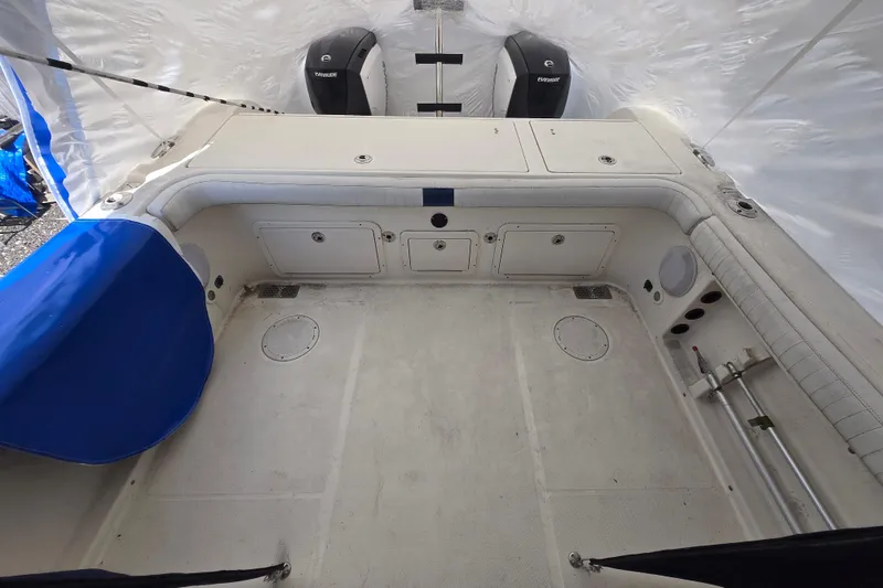 Slide: The Image of 2005 World Cat 250 DC boat interior with dual Evinrude engines, spacious deck, and storage compartments. - 6