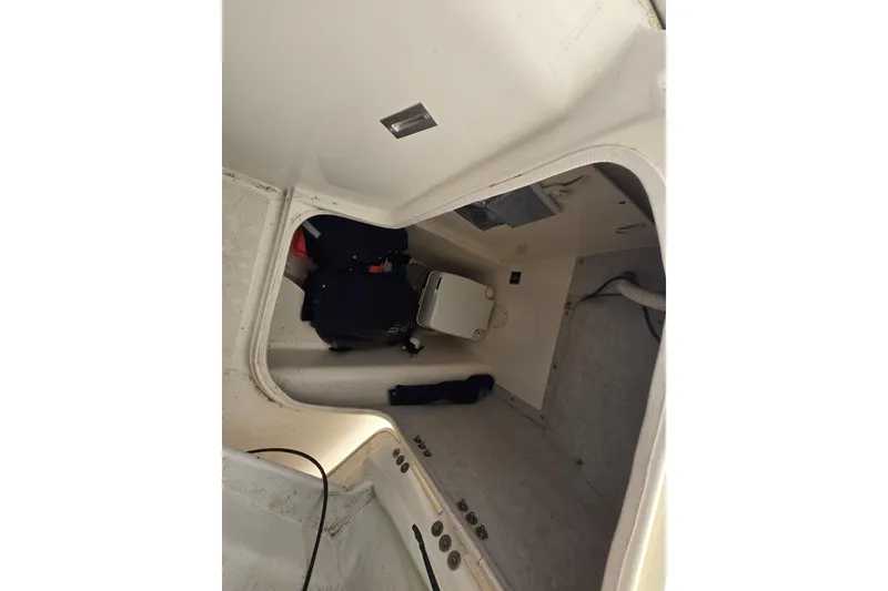 Slide: The Image of Interior cabin of a 2005 World Cat 250 DC boat, showing storage space and equipment. - 7