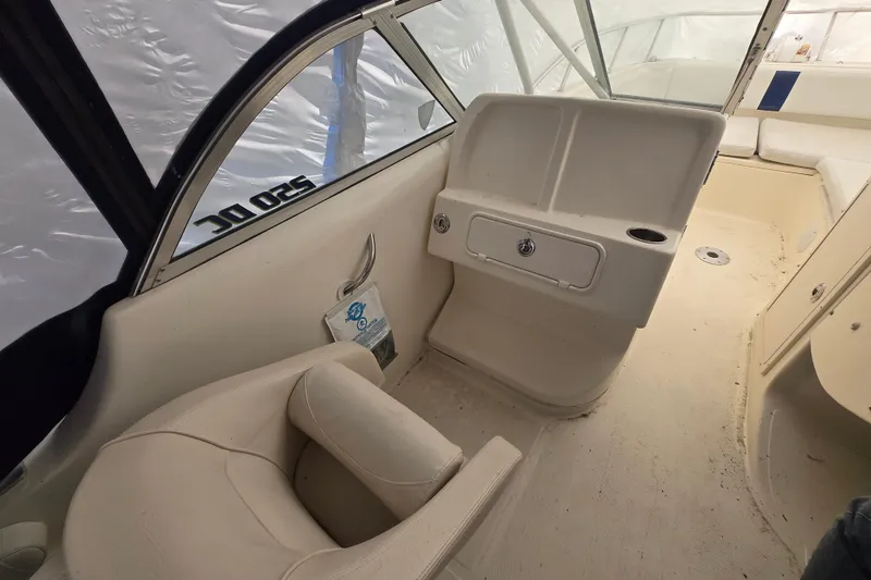 Slide: The Image of Interior of a 2005 World Cat 250 DC boat, featuring seating and storage compartments. - 8