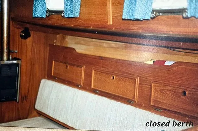 Slide: The Image of Interior of 1980 Cape Dory 33 sailboat with closed berth and wooden cabinetry. - 11