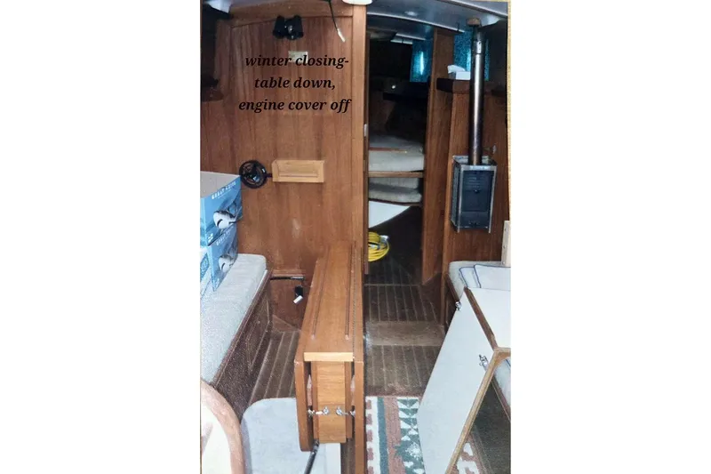 Slide: The Image of Interior of a 1980 Cape Dory 33 sailboat, table down, engine cover off. - 12