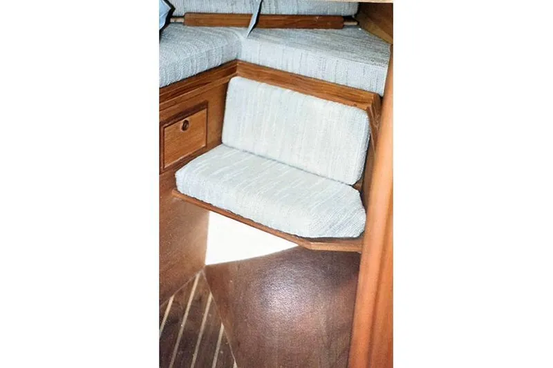 Slide: The Image of Interior steps of a 1980 Cape Dory 33 sailboat with cushioned seating. - 13