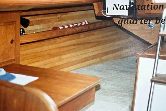 Slide: The Image of Interior of 1980 Cape Dory 33 sailboat, featuring wooden navigation station and quarter berth. - 15