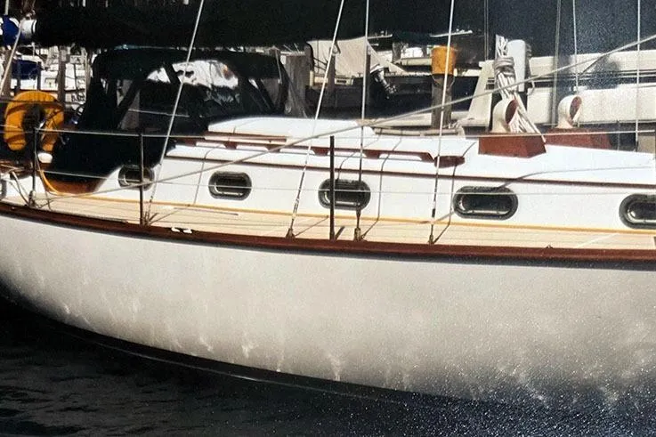 Slide: The Image of 1980 Cape Dory 33 sailboat docked, showcasing classic design and sleek lines. - 4