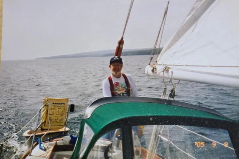 Slide: The Image of Man sailing a 1980 Cape Dory 33 yacht on open water. - 9