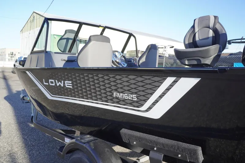 Slide: The Image of 2026 Lowe Fishing Machine 1625WT boat with sleek black design and modern seating. - 10