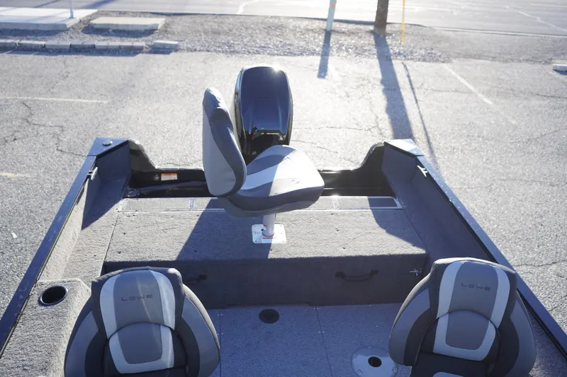 Slide: The Image of 2026 Lowe Fishing Machine 1625WT boat interior with seating and storage compartments. - 12