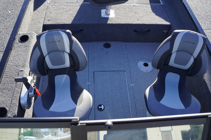 Slide: The Image of 2026 Lowe Fishing Machine 1625WT interior with two gray seats and carpeted flooring. - 13