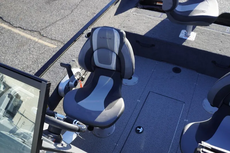 Slide: The Image of 2026 Lowe Fishing Machine 1625WT boat interior with swivel seats and control panel. - 15