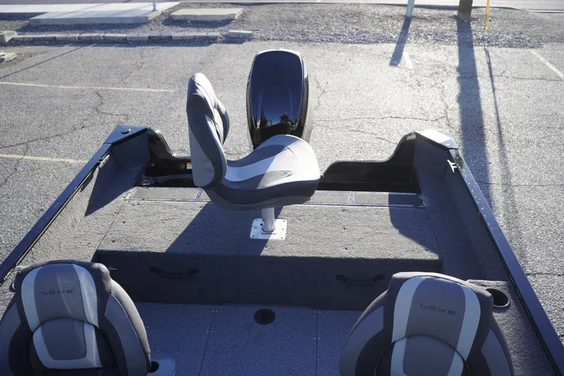 Slide: The Image of 2026 Lowe Fishing Machine 1625WT boat interior with seating and storage compartments. - 16