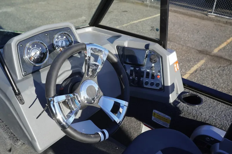 Slide: The Image of 2026 Lowe Fishing Machine 1625WT dashboard with steering wheel and control panel. - 17