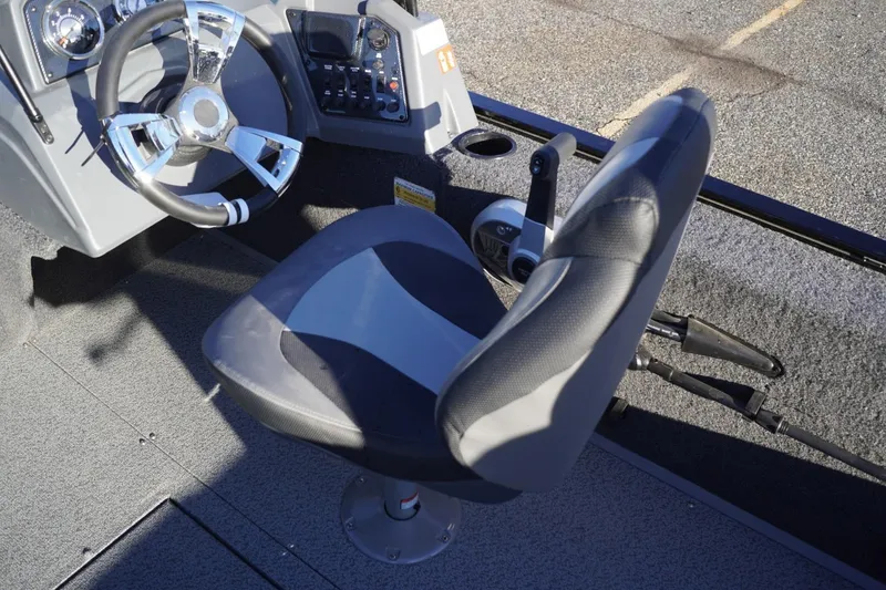 Slide: The Image of 2026 Lowe Fishing Machine 1625WT boat interior with steering wheel and seat. - 20