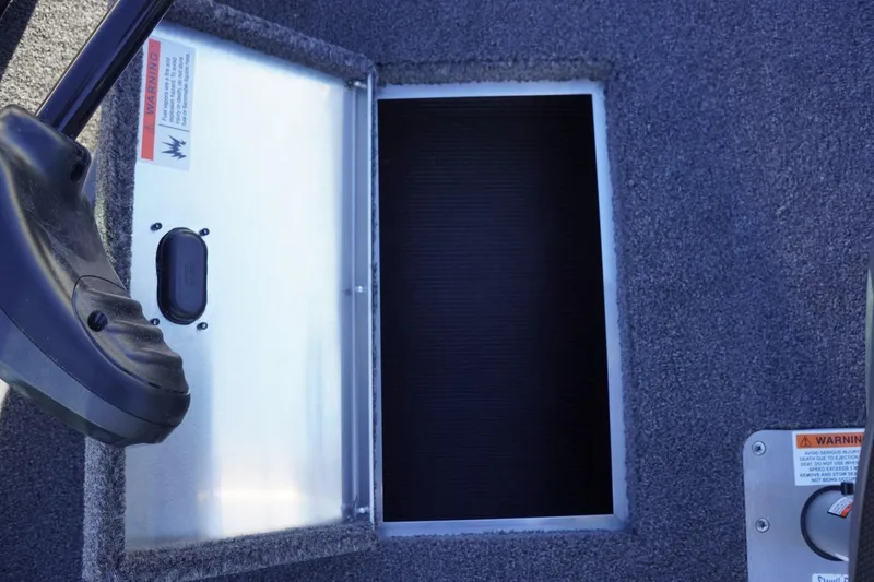 Slide: The Image of 2026 Lowe Fishing Machine 1625WT boat interior with storage compartment and control panel. - 25