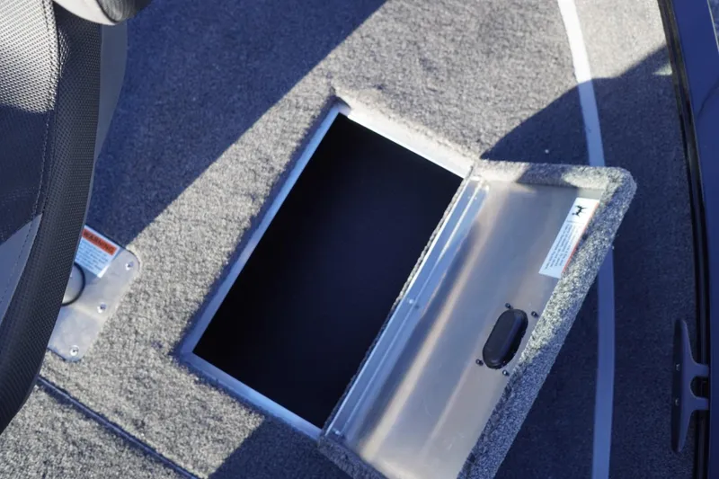 Slide: The Image of 2026 Lowe Fishing Machine 1625WT boat storage compartment with open hatch. - 26