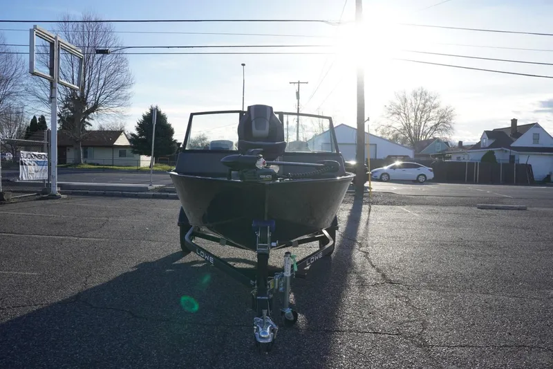 Slide: The Image of 2026 Lowe Fishing Machine 1625WT boat parked in a sunny lot. - 3