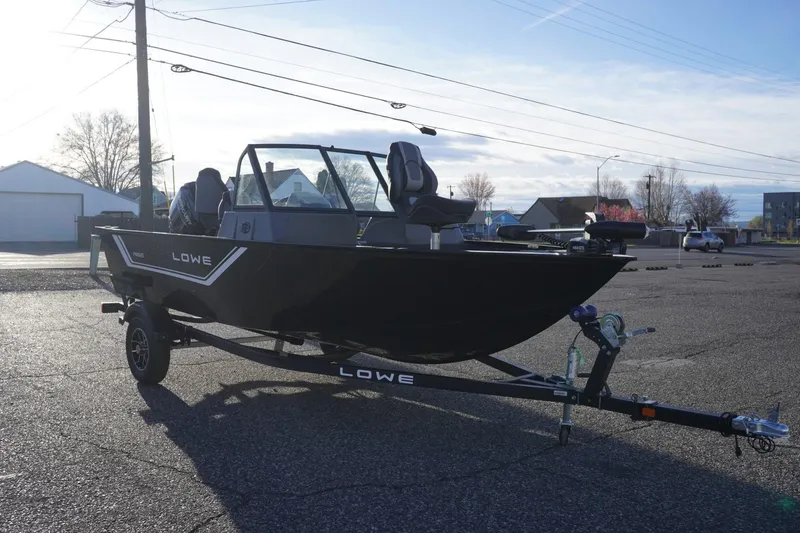Slide: The Image of 2026 Lowe Fishing Machine 1625WT on trailer, parked outdoors under clear sky. - 4