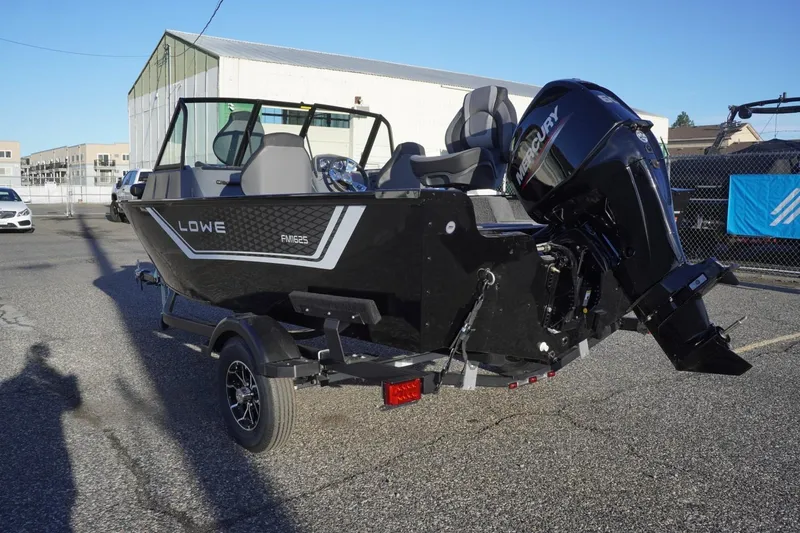 Slide: The Image of 2026 Lowe Fishing Machine 1625WT boat with Mercury outboard motor on trailer. - 9