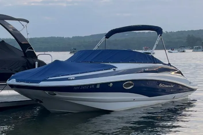 Slide: The Image of 2014 Crownline Eclipse E2 boat with blue cover on a calm lake. - 3