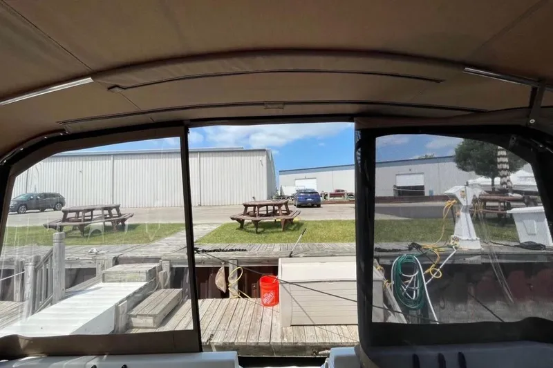Slide: The Image of Interior view from a 1996 Mainship 40 Sedan Bridge, overlooking a marina dock. - 12