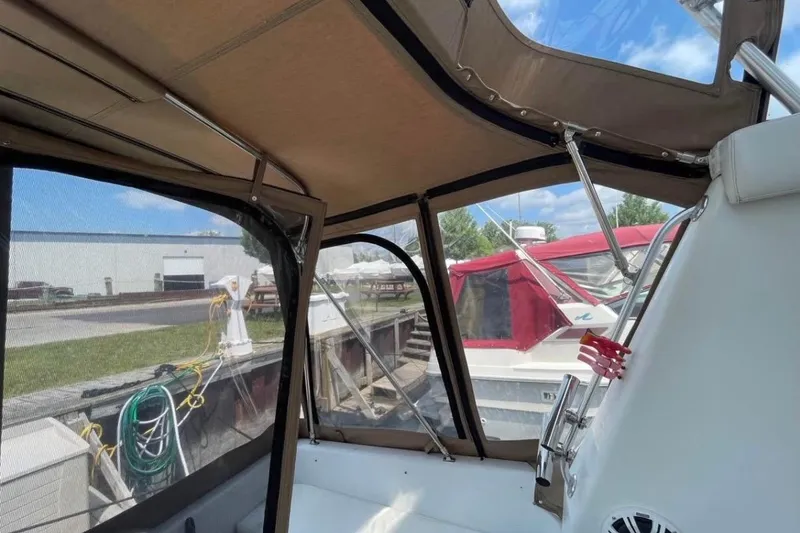 Slide: The Image of Interior view of a 1996 Mainship 40 Sedan Bridge boat with canopy and dockside view. - 13