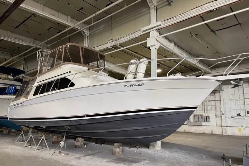 Slide: The Image of 1996 Mainship 40 Sedan Bridge yacht in indoor storage, elevated on stands. - 3