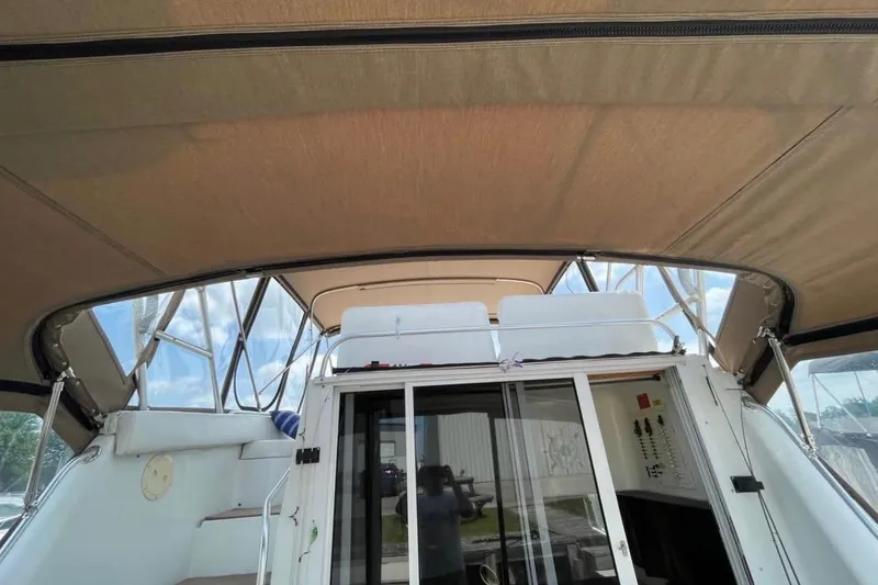 Slide: The Image of 1996 Mainship 40 Sedan Bridge interior view with canopy and sliding doors. - 5