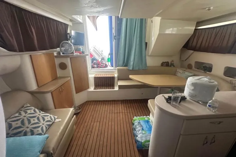 Slide: The Image of Interior of a 1996 Mainship 40 Sedan Bridge with cozy seating and wooden flooring. - 8