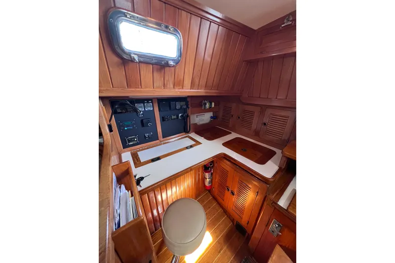 Slide: The Image of Interior of 1990 Cabo Rico 38R sailboat with wooden cabinetry and navigation equipment. - 14