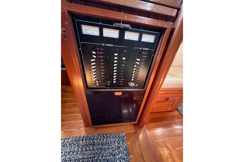 Slide: The Image of Electrical panel of a 1990 Cabo Rico 38R yacht, featuring DC and AC power controls. - 17