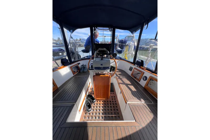 Slide: The Image of Cockpit of 1990 Cabo Rico 38R sailboat with wooden accents and steering wheel. - 18