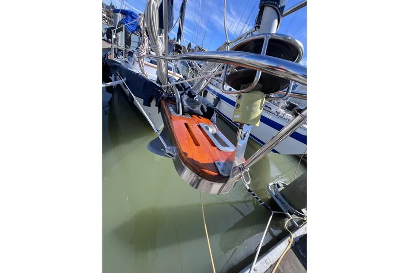 Slide: The Image of 1990 Cabo Rico 38R sailboat with polished wood and metal details docked in marina. - 21