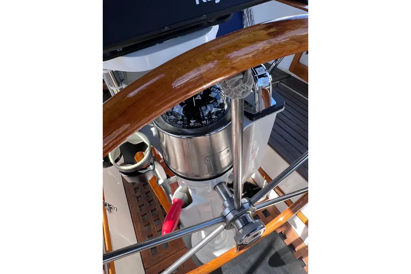 Slide: The Image of Steering wheel and compass of a 1990 Cabo Rico 38R sailboat. - 23