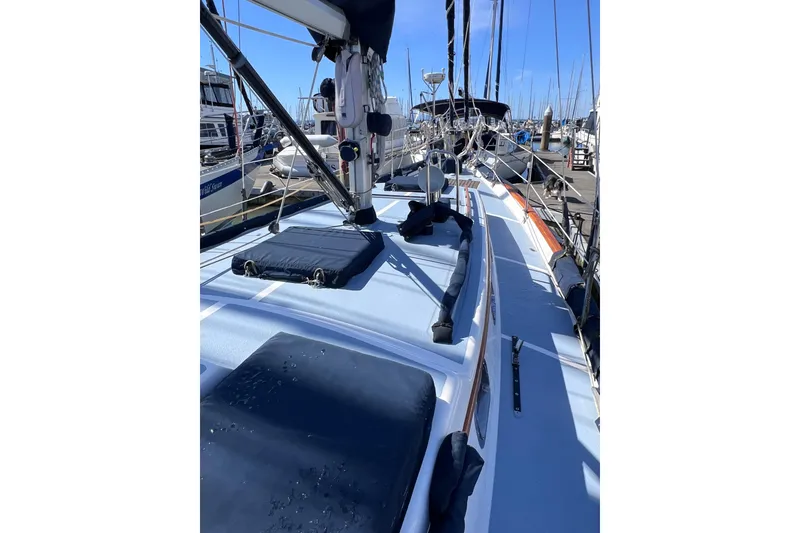 Slide: The Image of Sailboat deck view of 1990 Cabo Rico 38R, docked in a marina under clear skies. - 24