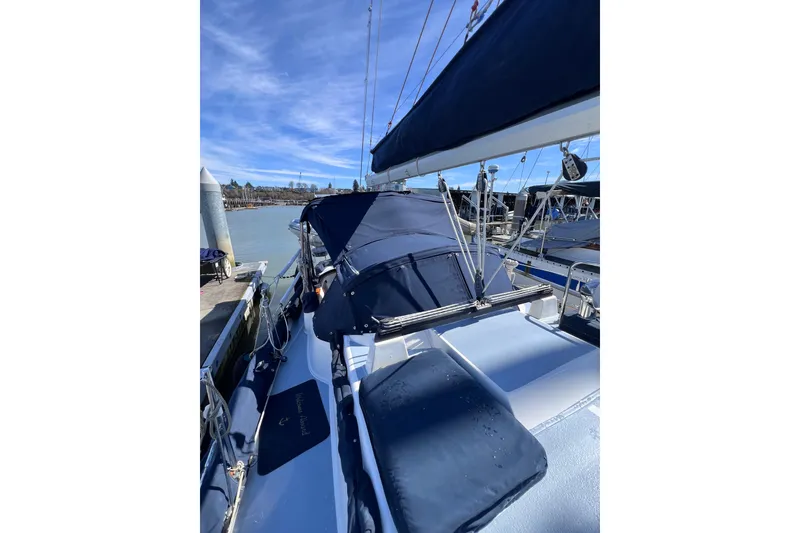 Slide: The Image of Sailboat Cabo Rico 38R, 1990 model, docked with blue canvas covers under clear sky. - 26